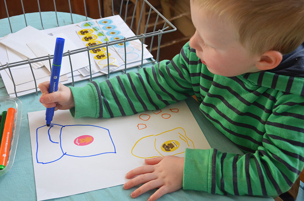 toddler drawing with markers