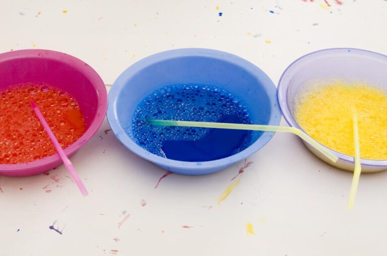 bubble painting supplies - three bowls of paint with straws in them