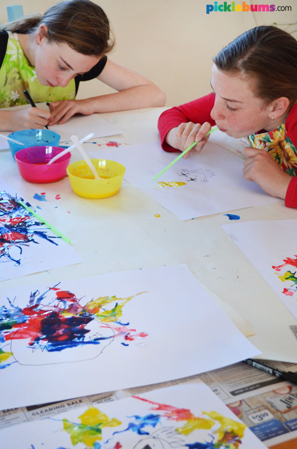 two children blow painting