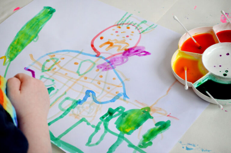 child's painting and paint pallet with q-tips for painting
