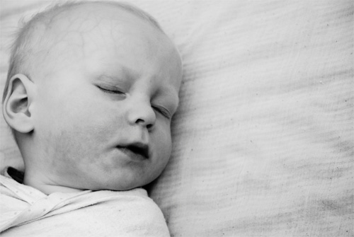 black and white photo of a baby's sleeping face