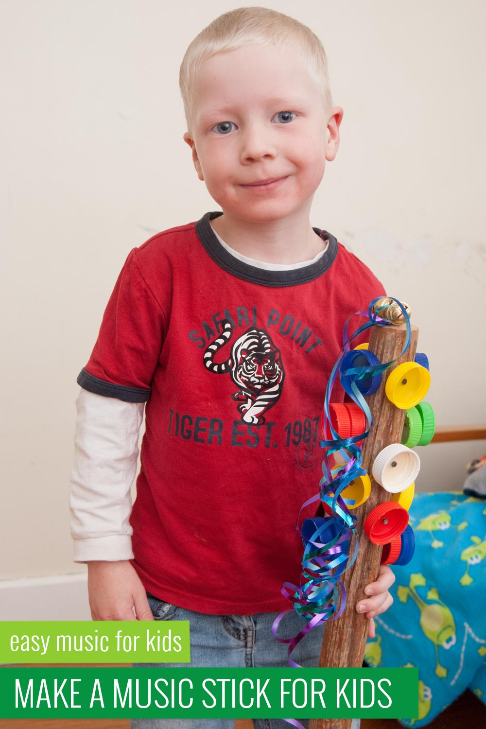preschooler holding a homemade percussion instrument music stick