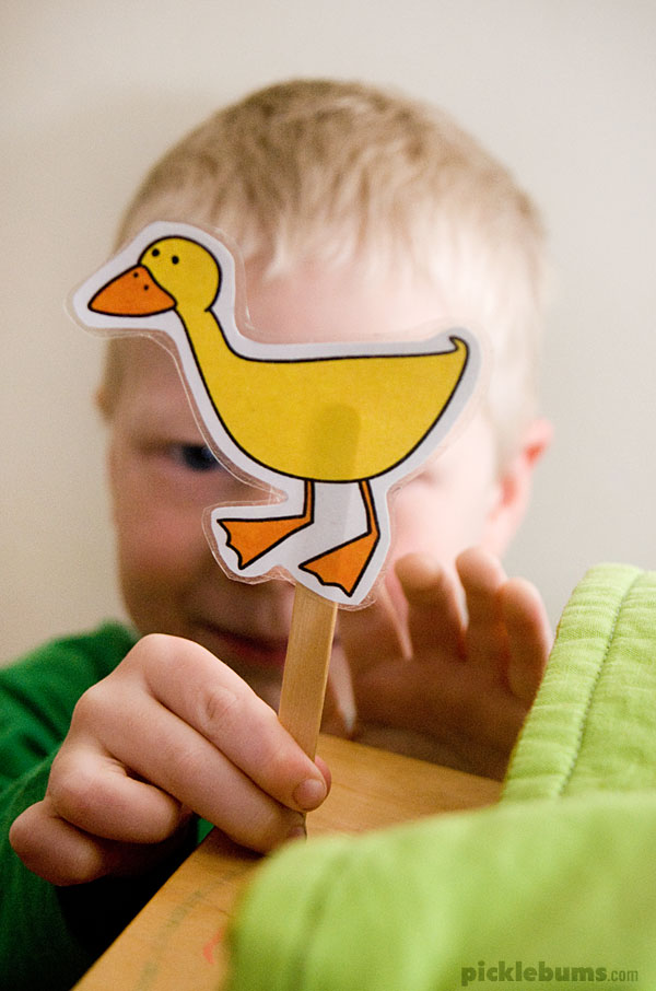 boy playing with duck puppet