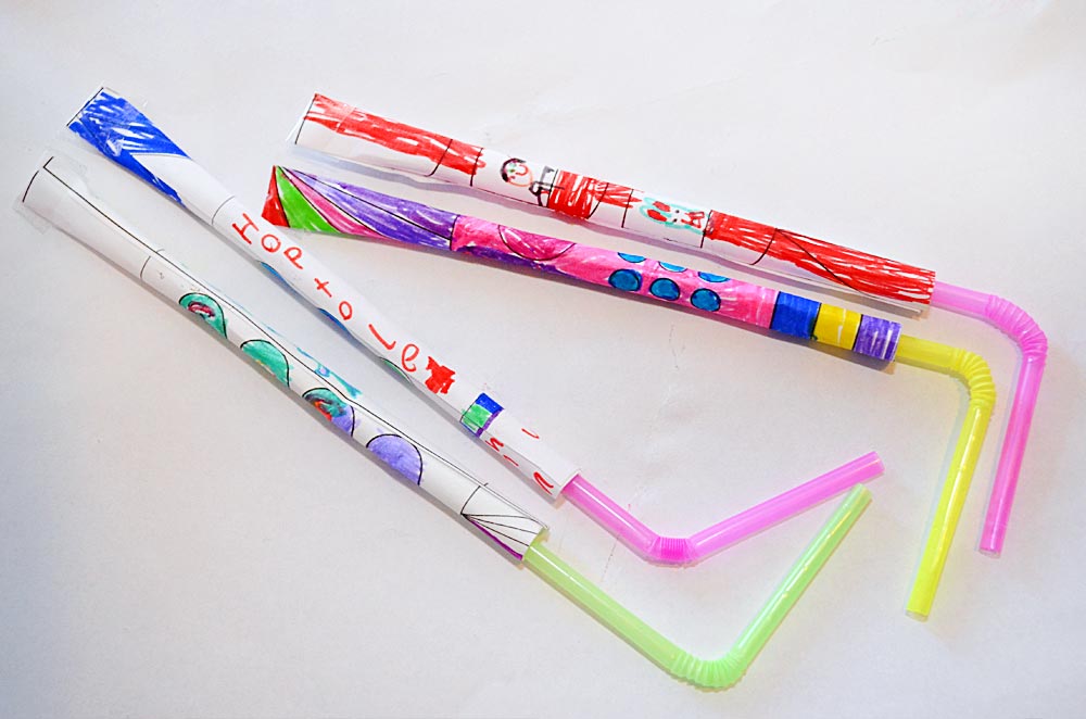 four paper and straw rockets 