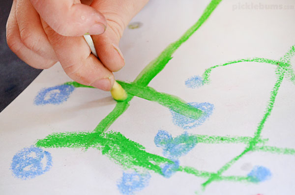 using cotton bud to rub oil pastel drawing with oil to make paint