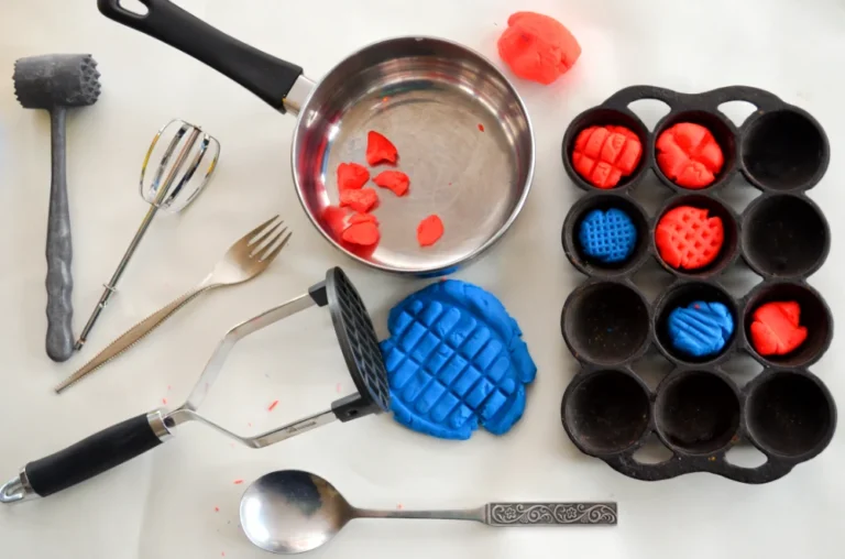 red and blue play-doh with kitchen utensils