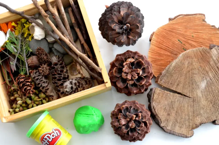 a tub of green Llay-doh with nature items