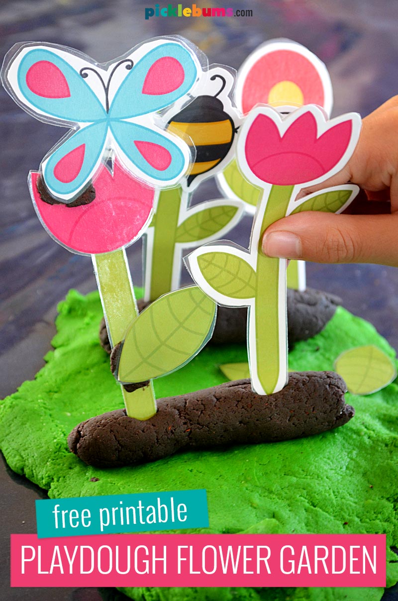 child's hand holding printable flower garde playdough accessories with play dough