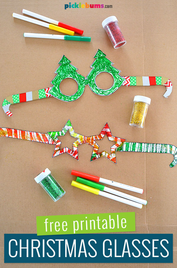 printable Christmas glasses on cardboard background with markers and glitter