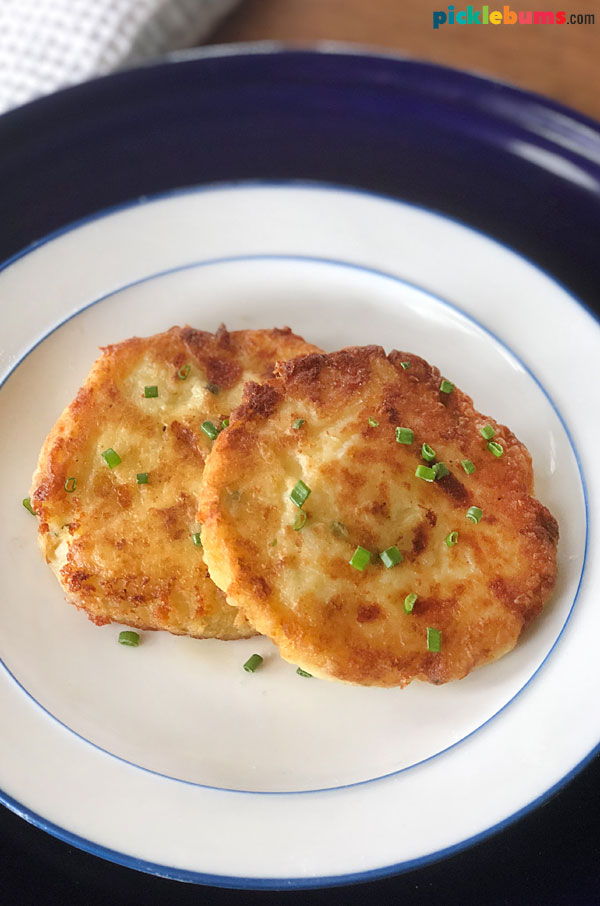 two mashed potato cakes on a white plate