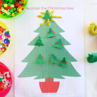 christmas tree playdough mat with bowls of sequins, beads and paper shapes