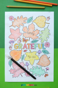 printable colouring page with leaves flowers and the word grateful in the middle with black pen on the paper
