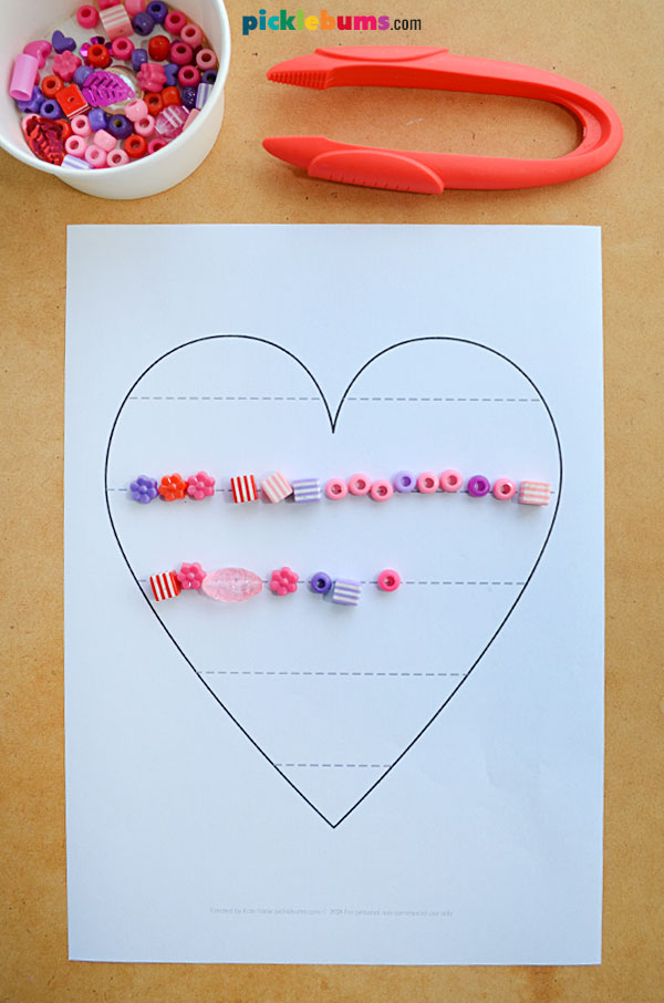 heart fine motor mat with loose parts and tweezers