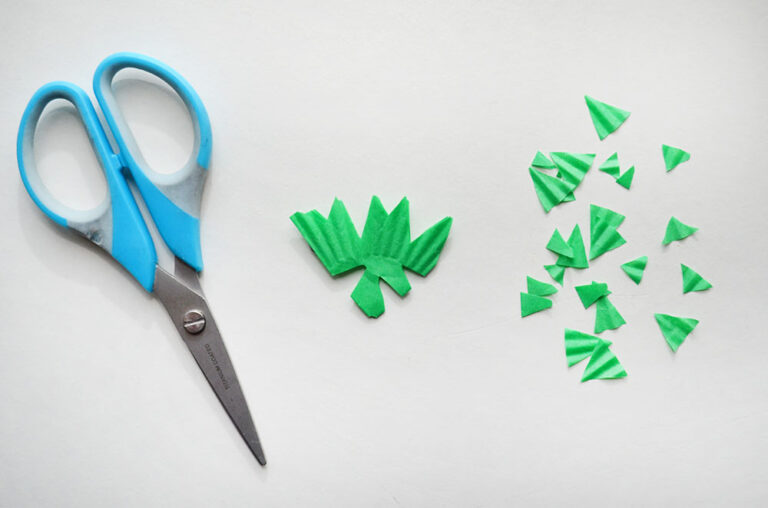 cutting cupcake liner to make a snowflake